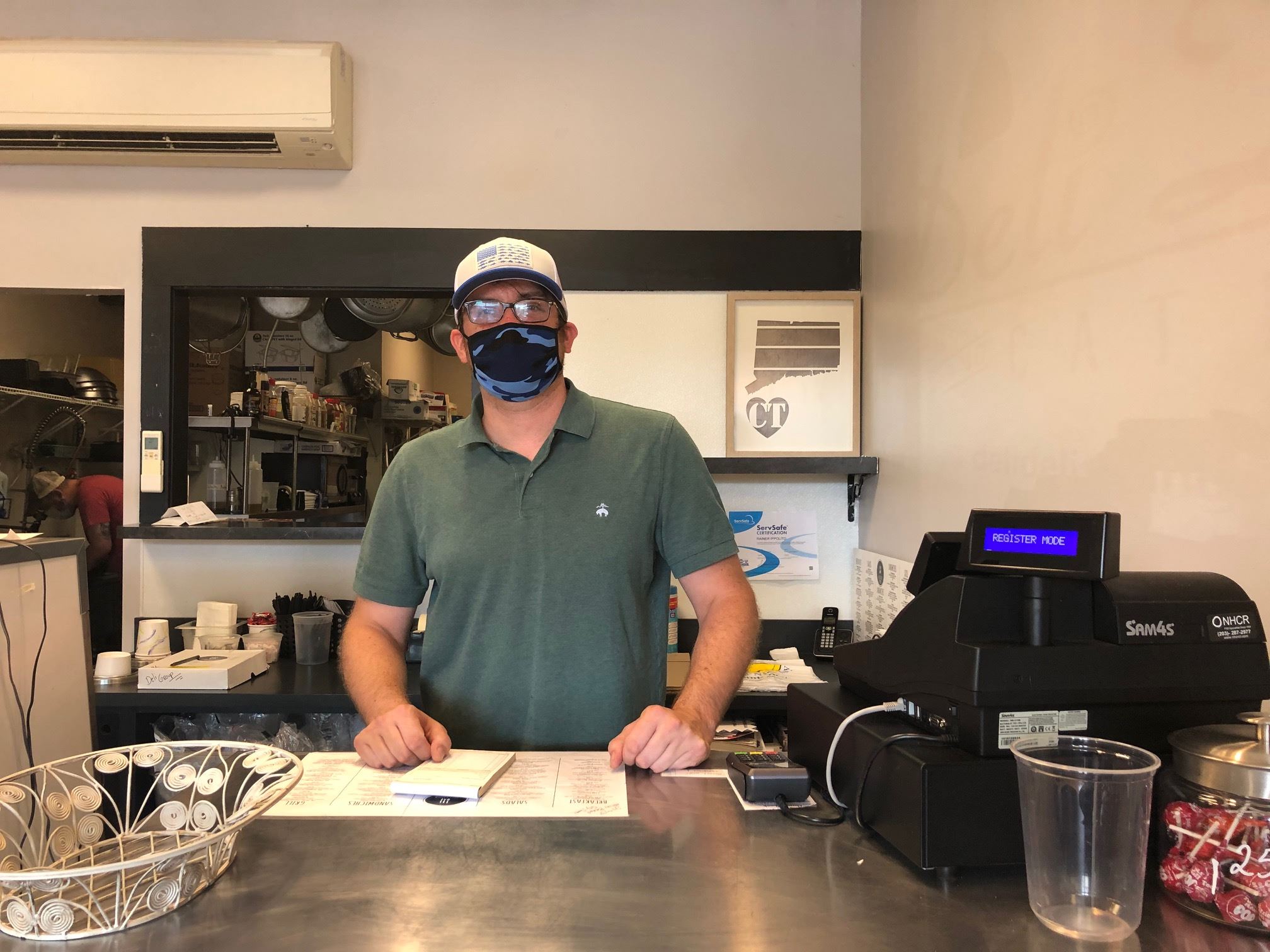 New Deli Delish owner Rainer Ippolito at counter